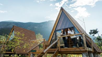 
		Two friends spend a vacation together and stand on the veranda of their cabin
	